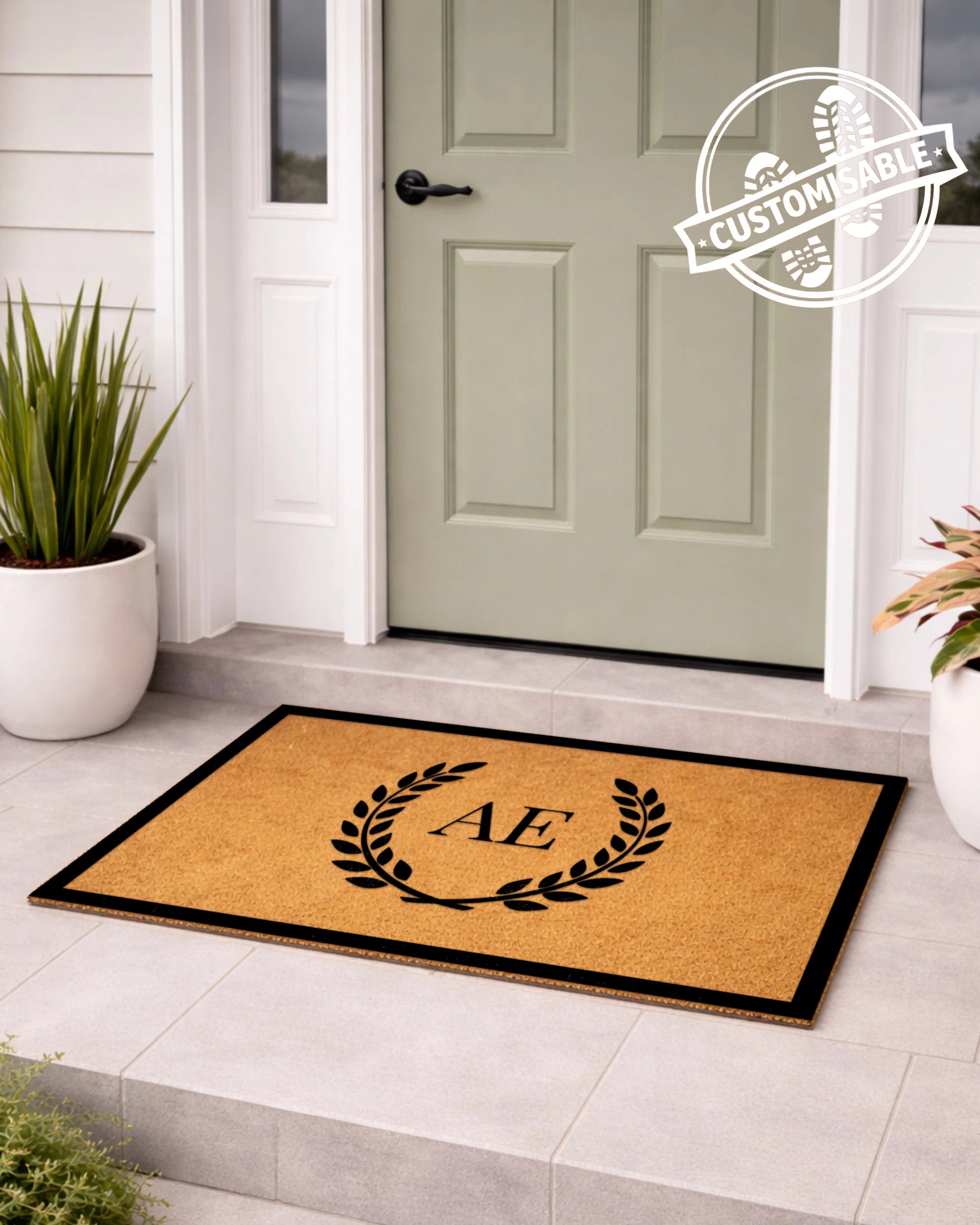 Doormat with a monogram 'A' on a tiled floor in front of a door, with a customizable badge in the corner. [VARIANT: TWO INITIALS / BORDER]