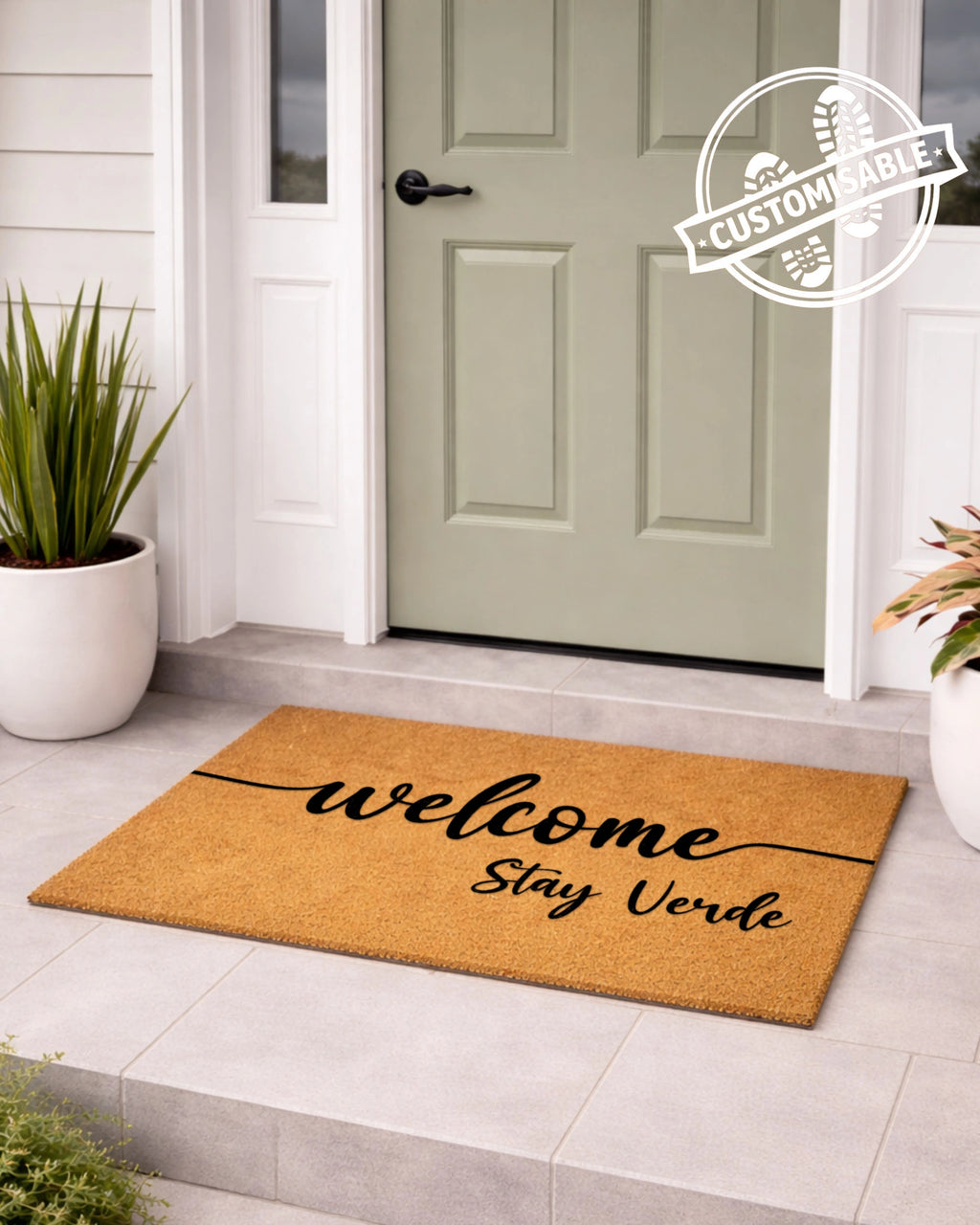 Doormat with 'welcome stay verde' text in front of a green door, with 'Customizable' label. [VARIANT: STANDARD]