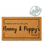Doormat with text 'THERE'S NO PLACE LIKE Nanny & Poppy's HOUSE' on a white background