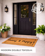 Front door with a doormat and plants on a light-colored floor.