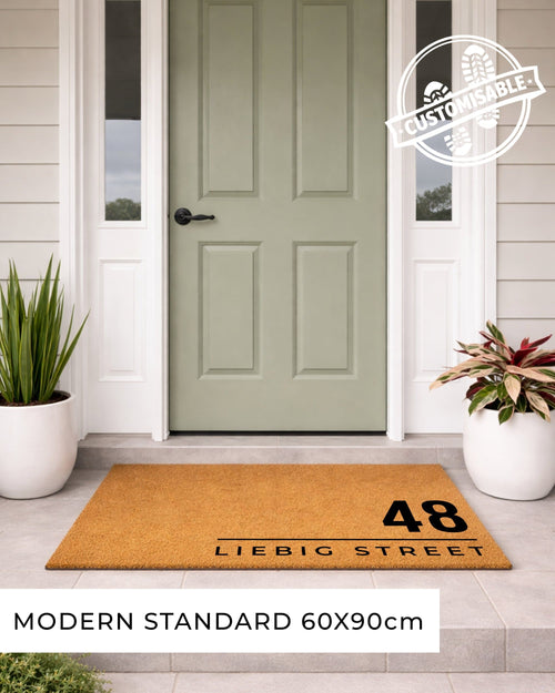 Doormat with address '48 Liebig Street' in front of a green door on a house exterior.