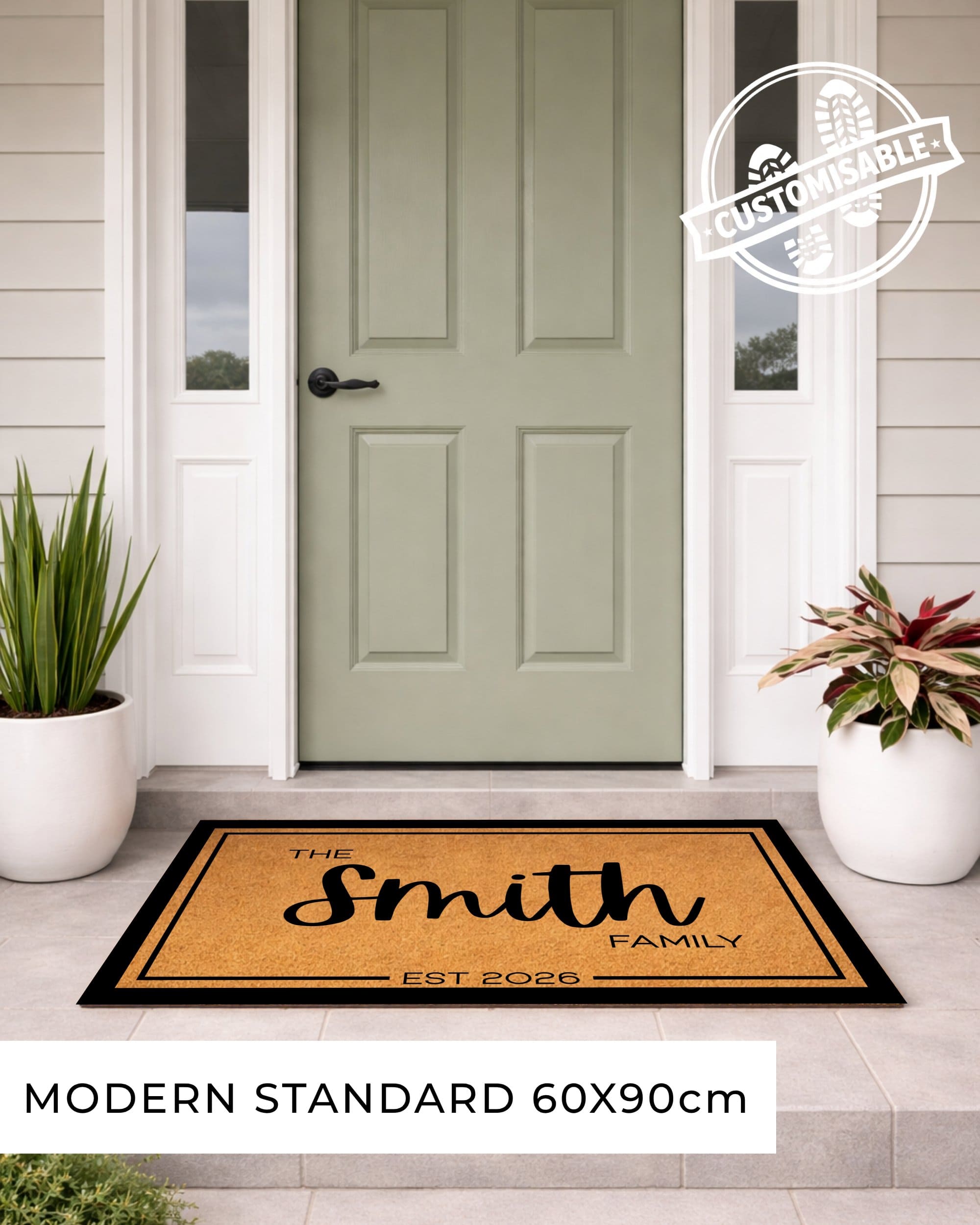 Doormat with 'The Smith Family' design in front of a green door on a house exterior. [VARIANT: BORDER-EST]