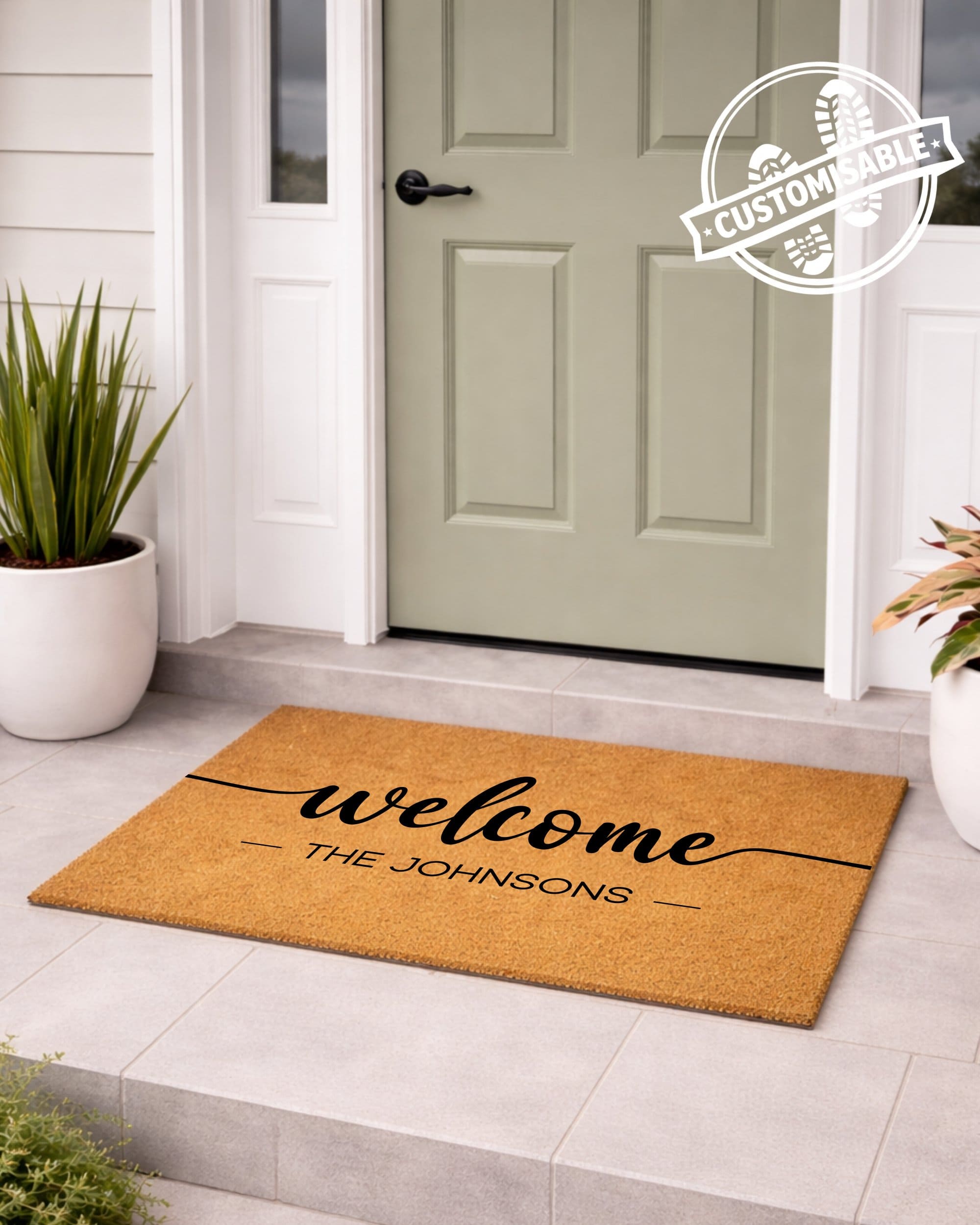 Personalized welcome mat with 'welcome THE JOHNSONs' text in front of a door. [VARIANT: STANDARD]