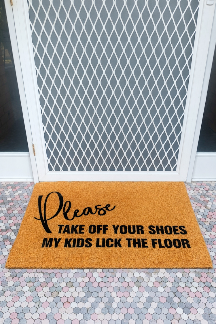 Doormat with humorous text on a patterned floor