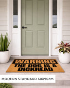 Doormat with humorous text on a front door of a house [variant: dog-dickhead]