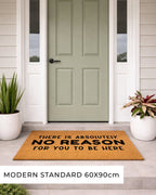 Doormat with text in front of a green door on a porch.