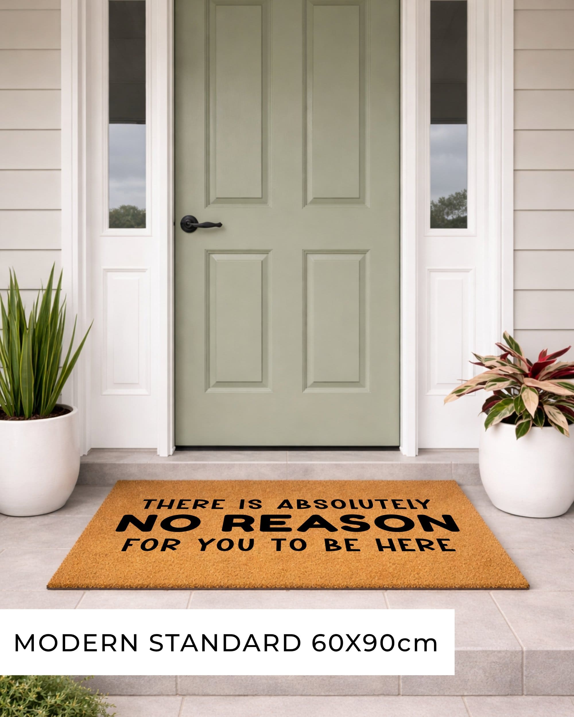 Doormat with text in front of a green door on a porch.