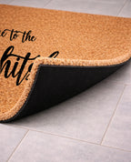 Doormat with text on a tiled floor